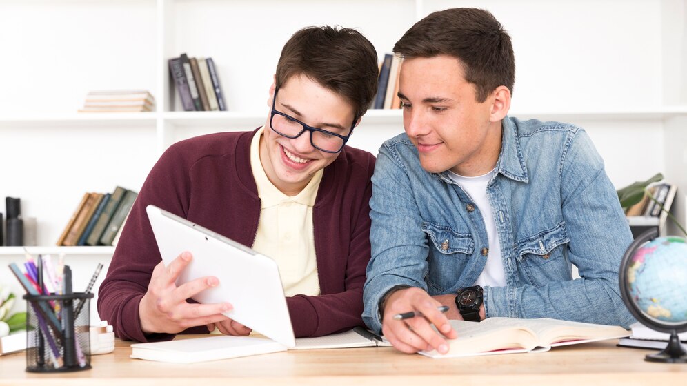 couple-classmates-looking-tablet_23-2148166314
