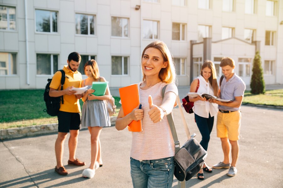 happy-beautiful-girl-standing-with-note-books-backpack-showing-thumb-up-smiling_8353-6390