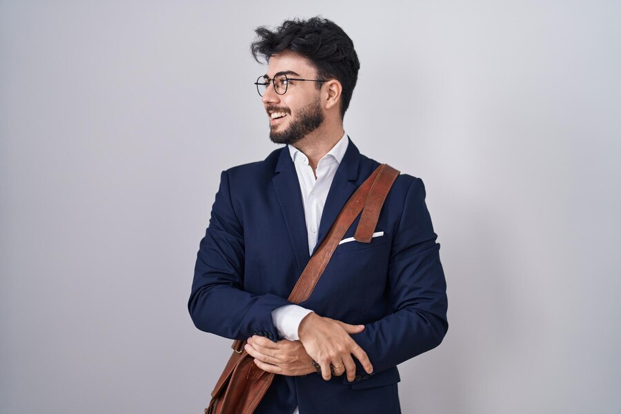 hispanic-man-with-beard-wearing-business-clothes-looking-away-side-with-smile-face-natural-expression-laughing-confident_839833-24095
