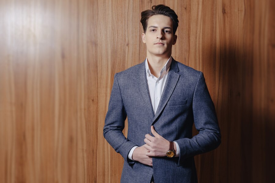 stylish-guy-jacket-office-simple-wooden-surface_78826-2378