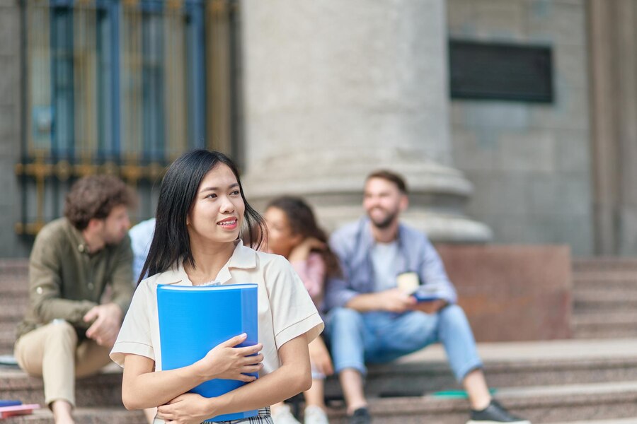 young-female-student-standing-front-university-building_160672-43526